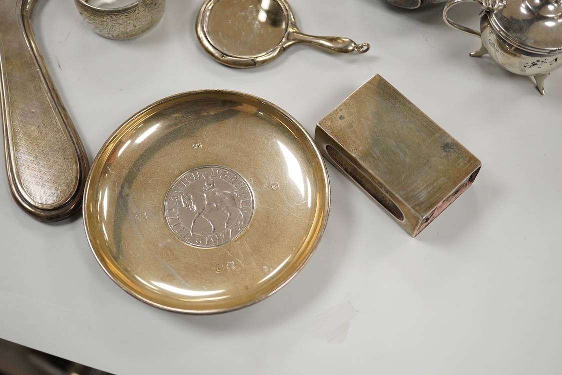Sundry small silver, including two cigarette cases, a match sleeve holder, three napkin rings, two condiments, matchbox sleeve, shaving brush canister, commemorative small dish, a mounted hand mirror and mounted handbag